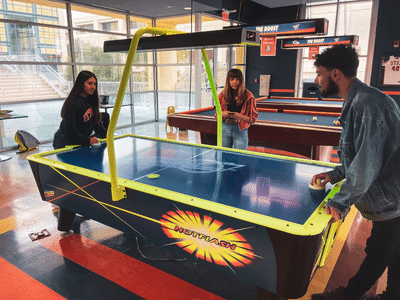 students playing air hockey